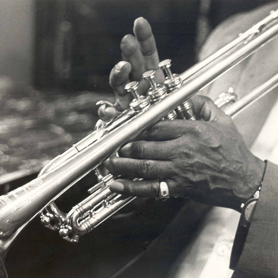 close-up of Louis Armstrong's hands playing the trumpet